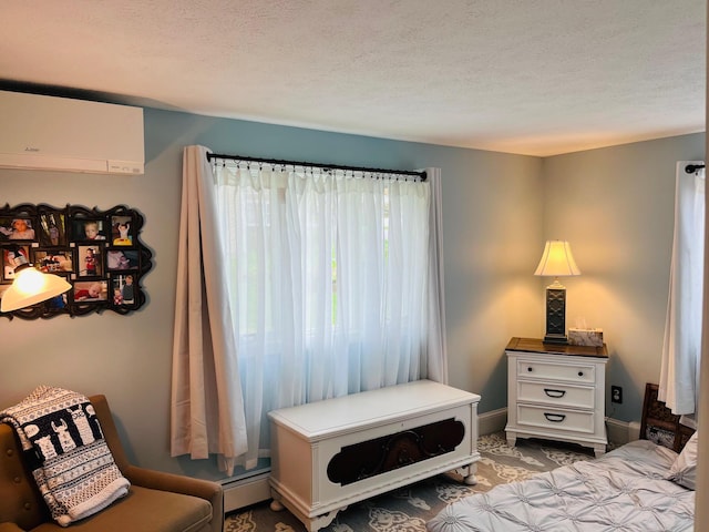 29 Chipman Rd, Sandwich, MA 02563 - bedroom with a textured ceiling, baseboards, and an AC wall unit