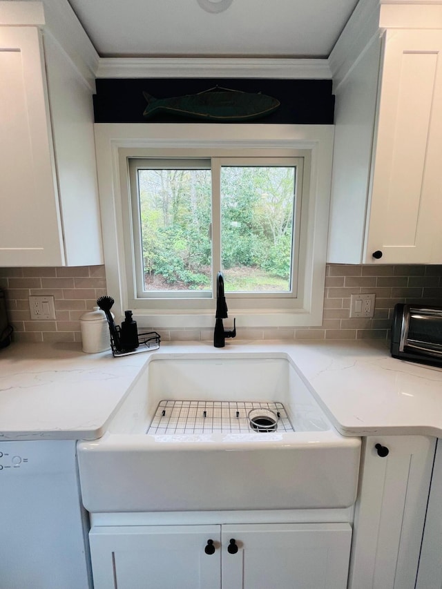 29 Chipman Rd, Sandwich, MA 02563 - interior details featuring white cabinets, a toaster, tasteful backsplash, and ornamental molding