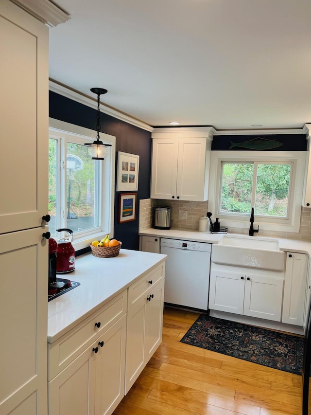 29 Chipman Rd, Sandwich, MA 02563 - kitchen featuring dishwasher, a sink, white cabinetry, decorative backsplash, and light countertops