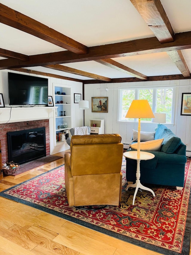 29 Chipman Rd, Sandwich, MA 02563 - living room with beam ceiling, a fireplace, baseboard heating, and wood finished floors