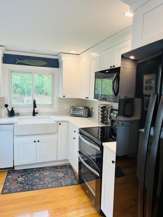 29 Chipman Rd, Sandwich, MA 02563 - kitchen featuring dishwasher, double oven range, a healthy amount of sunlight, a sink, and black microwave