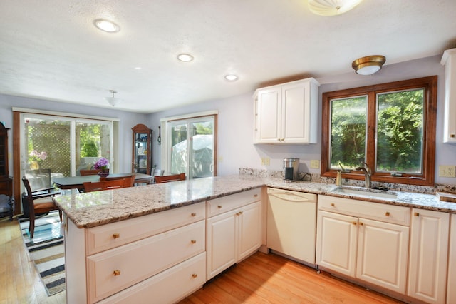 59 Whitecaps Dr, East Falmouth, MA 02536 - kitchen with dishwasher, a peninsula, light wood finished floors, light stone countertops, and recessed lighting