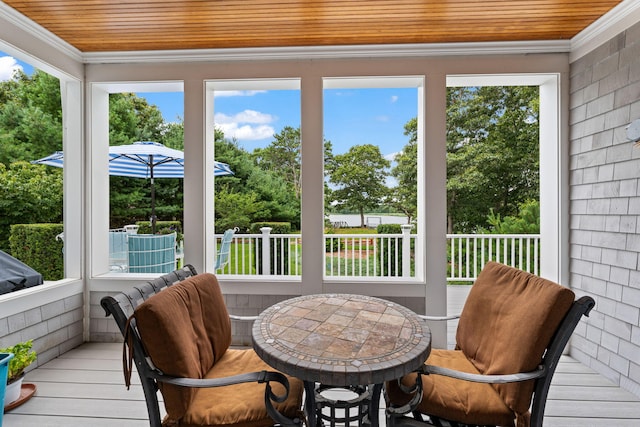 sunroom / solarium featuring wood ceiling and plenty of natural light