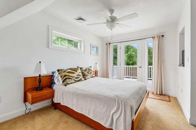 bedroom with access to exterior, light colored carpet, visible vents, and multiple windows