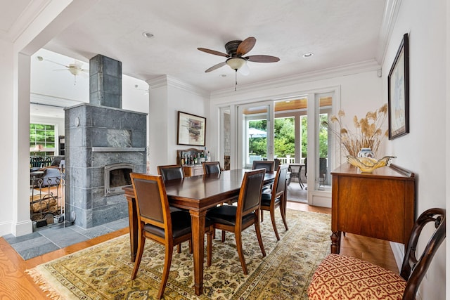 dining room featuring ornamental molding, wood finished floors, and a wealth of natural light