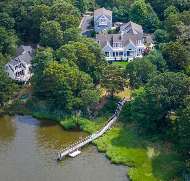 birds eye view of property featuring a water view and a view of trees