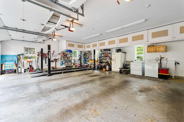 garage with washer and clothes dryer, a workshop area, and a garage door opener