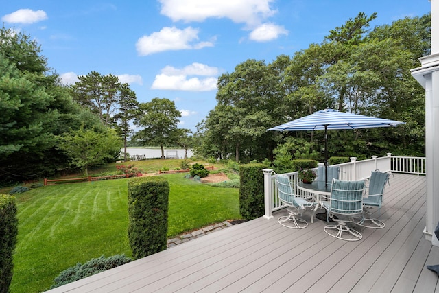 wooden deck featuring a yard and outdoor dining area