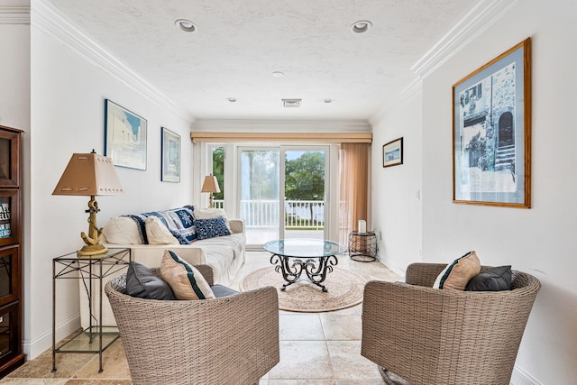 living room with ornamental molding, visible vents, a textured ceiling, and baseboards