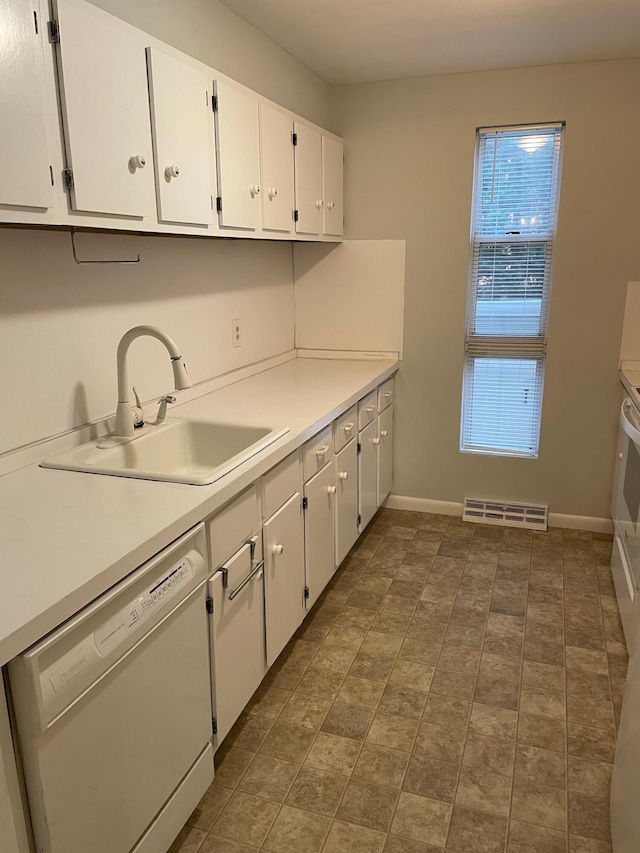 kitchen featuring sink, white cabinetry, and dishwasher