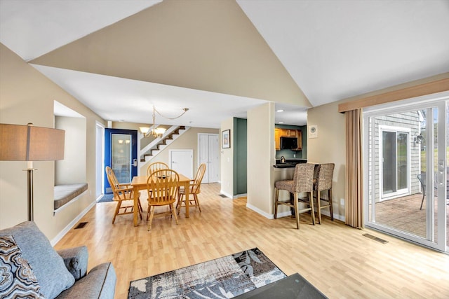 dining space featuring visible vents, stairway, baseboards, a notable chandelier, and light wood-style floors