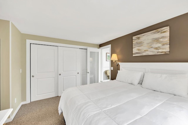 bedroom with carpet floors, baseboards, and a closet