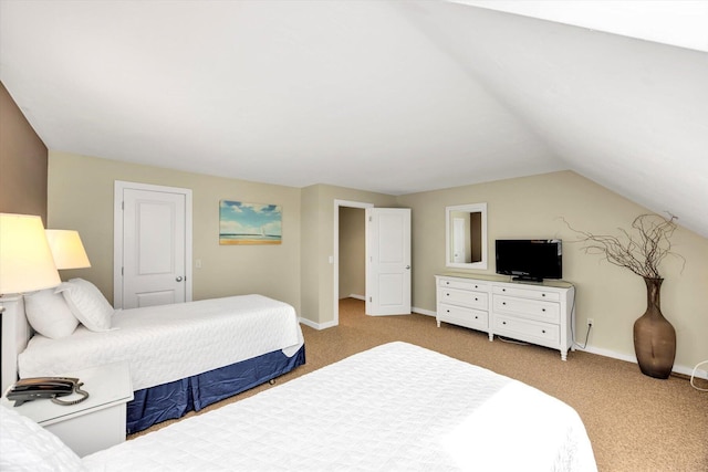 carpeted bedroom with baseboards and lofted ceiling