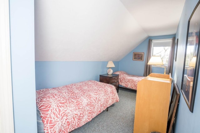 bedroom featuring carpet and lofted ceiling