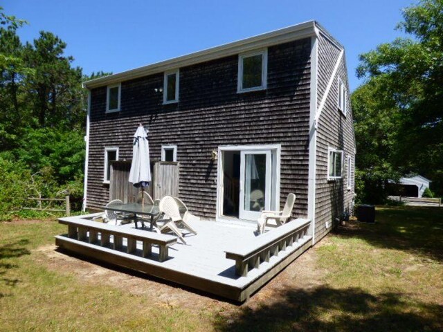 rear view of house featuring a yard