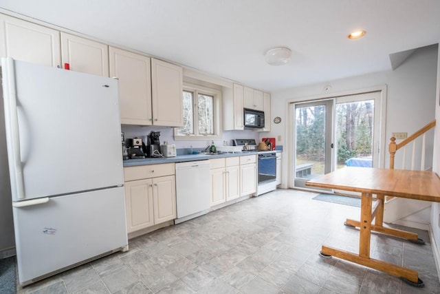 kitchen with sink and white appliances