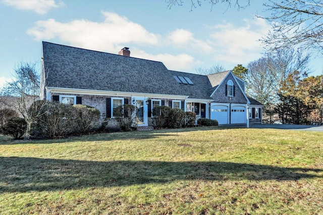 new england style home with a front yard and a garage