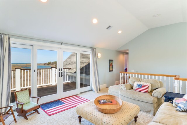 living room featuring vaulted ceiling, visible vents, carpet flooring, and french doors