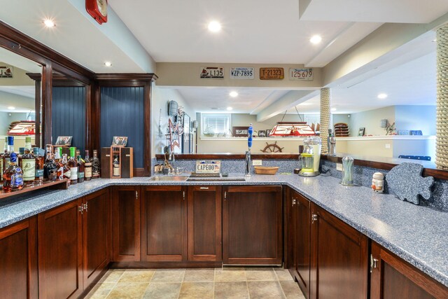 bar with a sink and recessed lighting