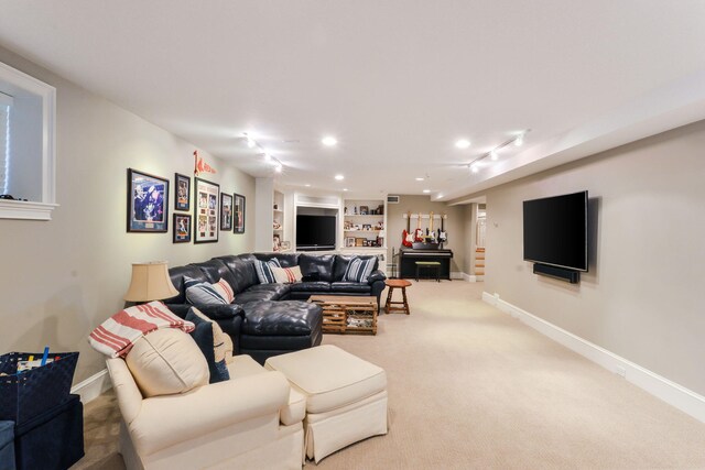 carpeted living area featuring recessed lighting and baseboards