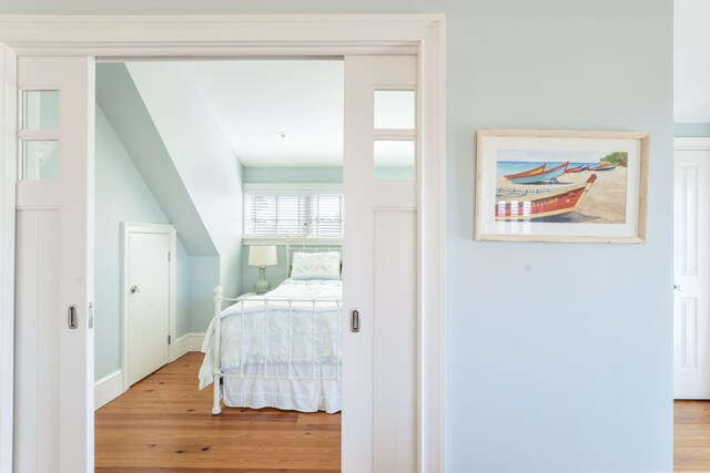 bedroom featuring baseboards and wood finished floors