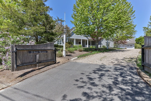 20 Boat Meadow Way, Eastham, MA 02642 - view of front facade with a porch and a garage