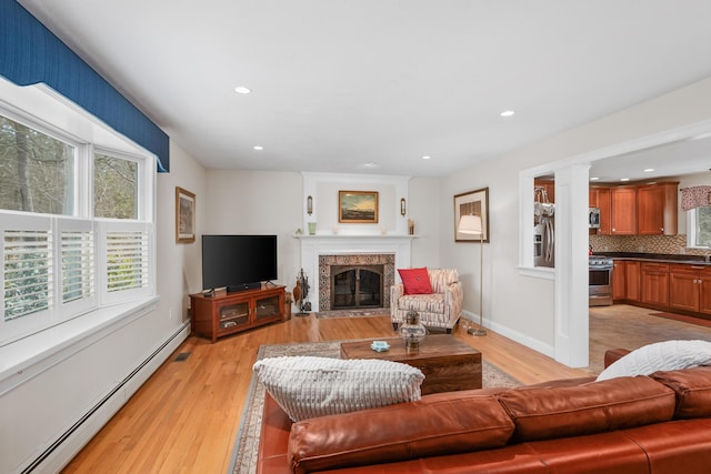 29 Water View Cir, Centerville, MA 02632 - living area with baseboard heating, light wood-style floors, a high end fireplace, recessed lighting, and baseboards