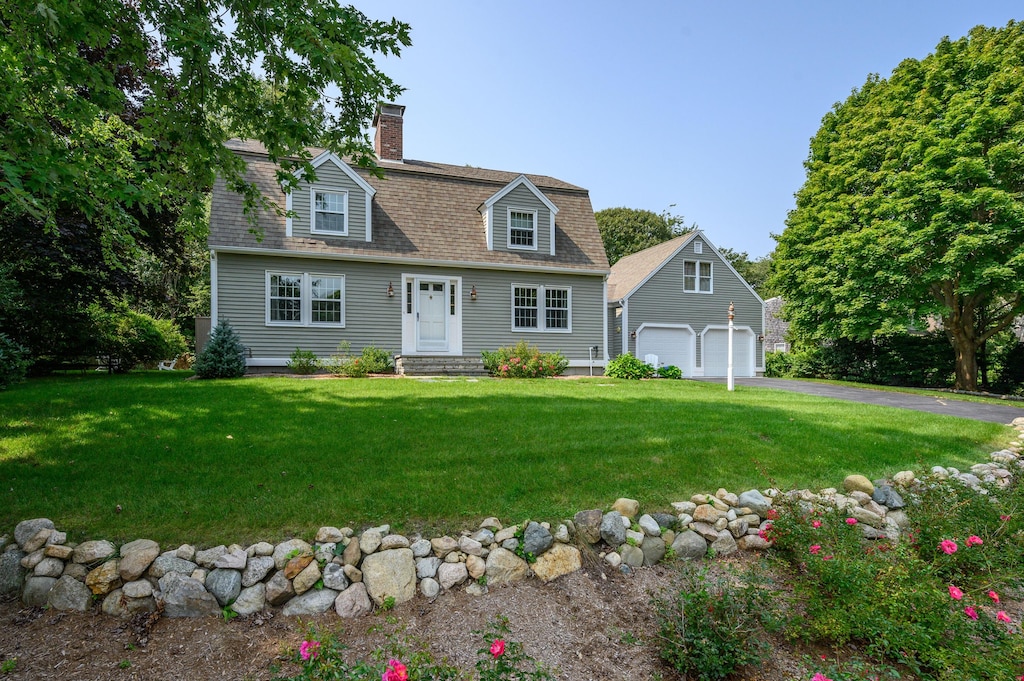 17 Cedar Point Cir, Centerville, MA 02632 - view of front of property featuring a garage, a chimney, a front lawn, entry steps, and asphalt driveway