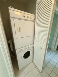 6 Sea Cliff Dr E Unit 6, Cedarville, MA 02360 - washroom with stacked washing machine and dryer and light tile patterned floors