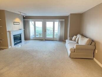 6 Sea Cliff Dr E Unit 6, Cedarville, MA 02360 - carpeted living room with a glass covered fireplace and rail lighting