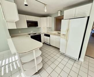 6 Sea Cliff Dr E Unit 6, Cedarville, MA 02360 - kitchen with white fridge with ice dispenser, black microwave, dishwasher, light tile patterned floors, and light countertops