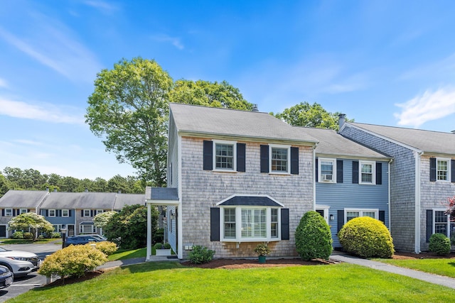 441 Buck Island Rd Unit B1, West Yarmouth, MA 02673 - view of front facade featuring a front yard, uncovered parking, and a shingled roof