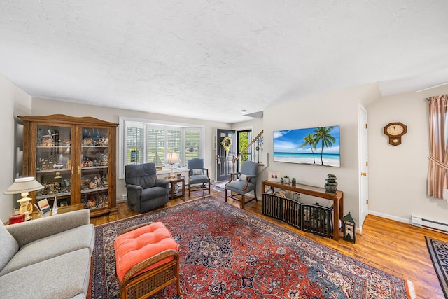 441 Buck Island Rd Unit B1, West Yarmouth, MA 02673 - living area with wood finished floors, a textured ceiling, and a baseboard radiator