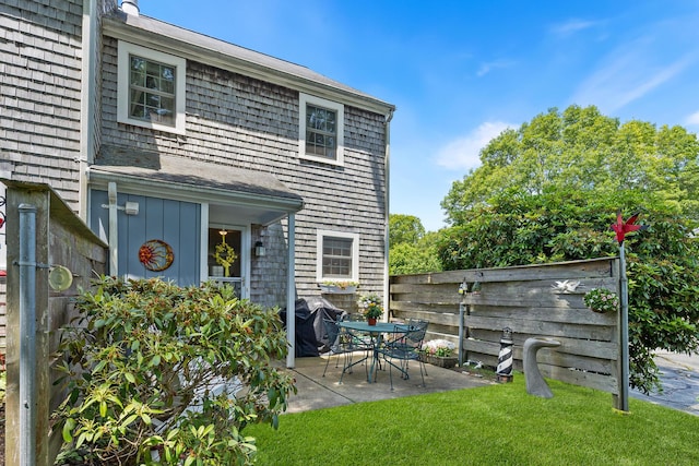 441 Buck Island Rd Unit B1, West Yarmouth, MA 02673 - back of house with a patio, board and batten siding, and roof with shingles