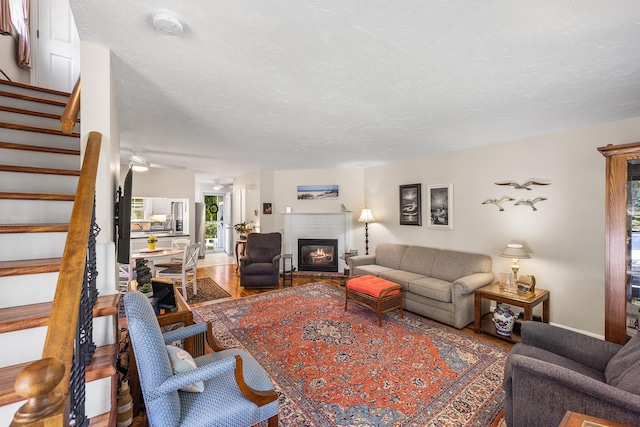 441 Buck Island Rd Unit B1, West Yarmouth, MA 02673 - living area with a glass covered fireplace, stairs, and wood finished floors