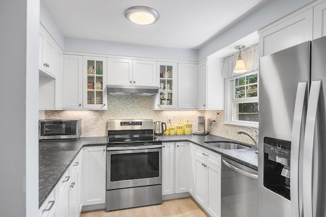 441 Buck Island Rd Unit B1, West Yarmouth, MA 02673 - kitchen featuring appliances with stainless steel finishes, under cabinet range hood, backsplash, and white cabinets