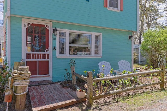 entrance to property featuring fence