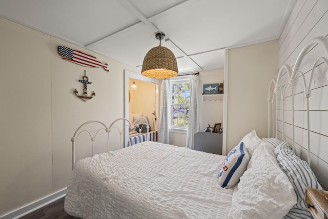 bedroom featuring baseboards and dark wood-style flooring