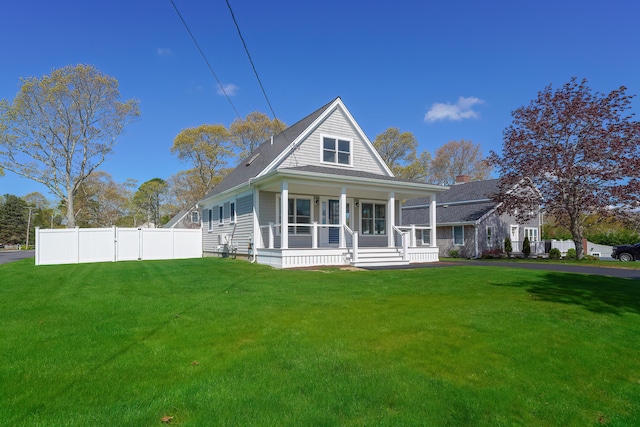 view of front of property with covered porch and a front lawn