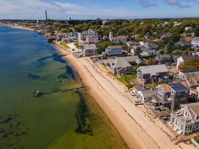 birds eye view of property with a water view and a view of the beach