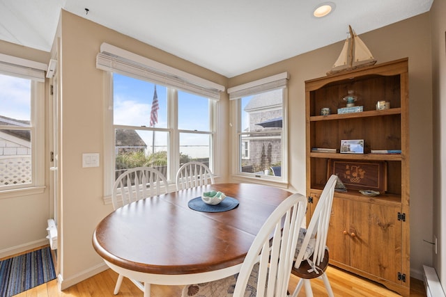 dining space featuring light hardwood / wood-style floors and baseboard heating