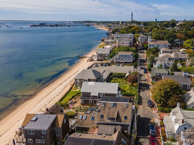 birds eye view of property with a water view and a beach view