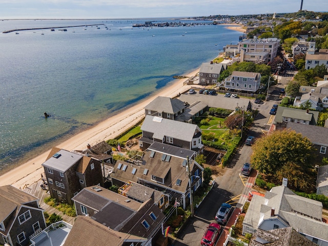 drone / aerial view featuring a beach view and a water view