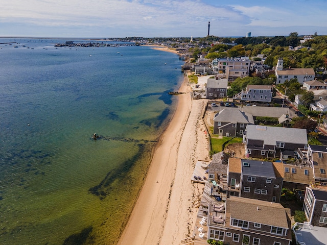 drone / aerial view featuring a water view and a beach view