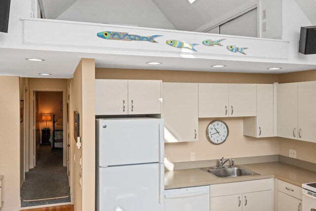 kitchen with sink, white appliances, and white cabinets