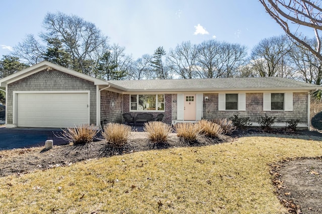 single story home with a garage and aphalt driveway