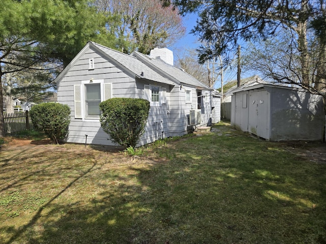 39 Alden Way, Hyannis, MA 02601 - view of side of home with a chimney, central AC unit, and roof with shingles