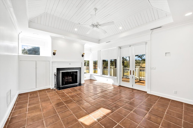 unfurnished living room featuring wood ceiling, ornamental molding, a tray ceiling, dark tile patterned flooring, and ceiling fan