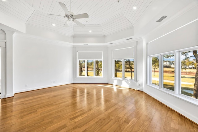 interior space featuring a towering ceiling, ceiling fan, wood ceiling, light hardwood / wood-style floors, and crown molding