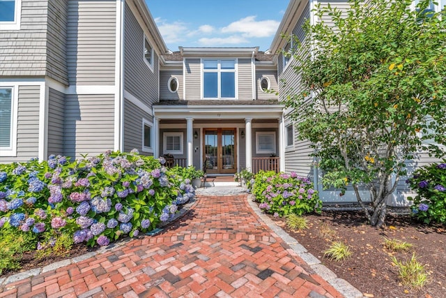 entrance to property featuring french doors and a porch